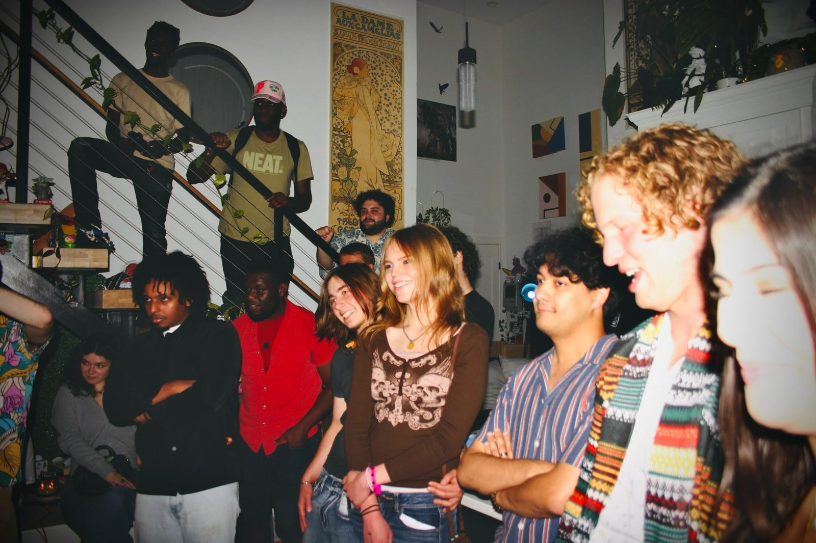A packed room of people smiling and talking during a show.